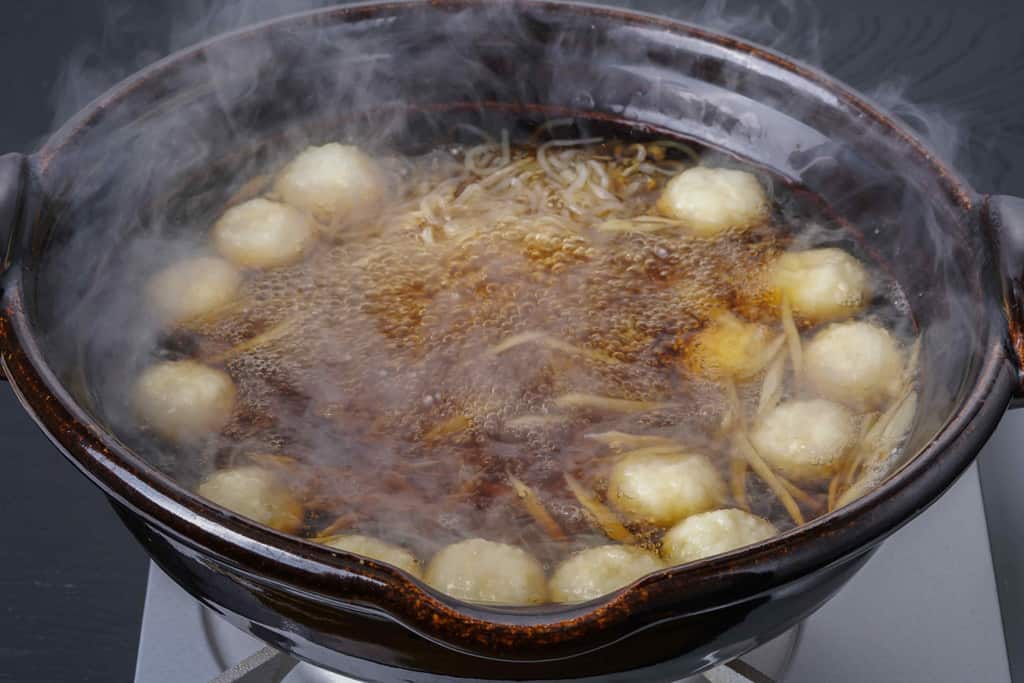 だまこもち・ささがきごぼう・糸こんにゃく・土鍋に入った煮立ったスープ、きりたんぽ鍋